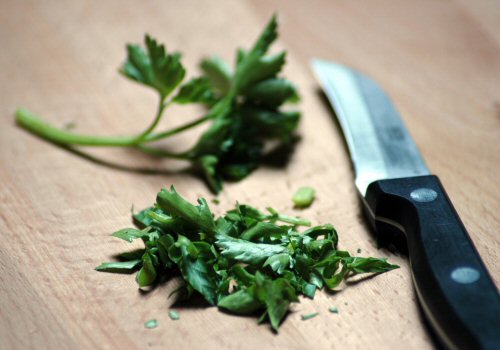 A Knife and parsley on a chopping board